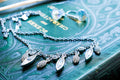 Vintage silver-tone Swarovski crystal necklace featuring round and marquise cut rhinestones, paired with matching crystal stud earrings, resting on a green antique book.