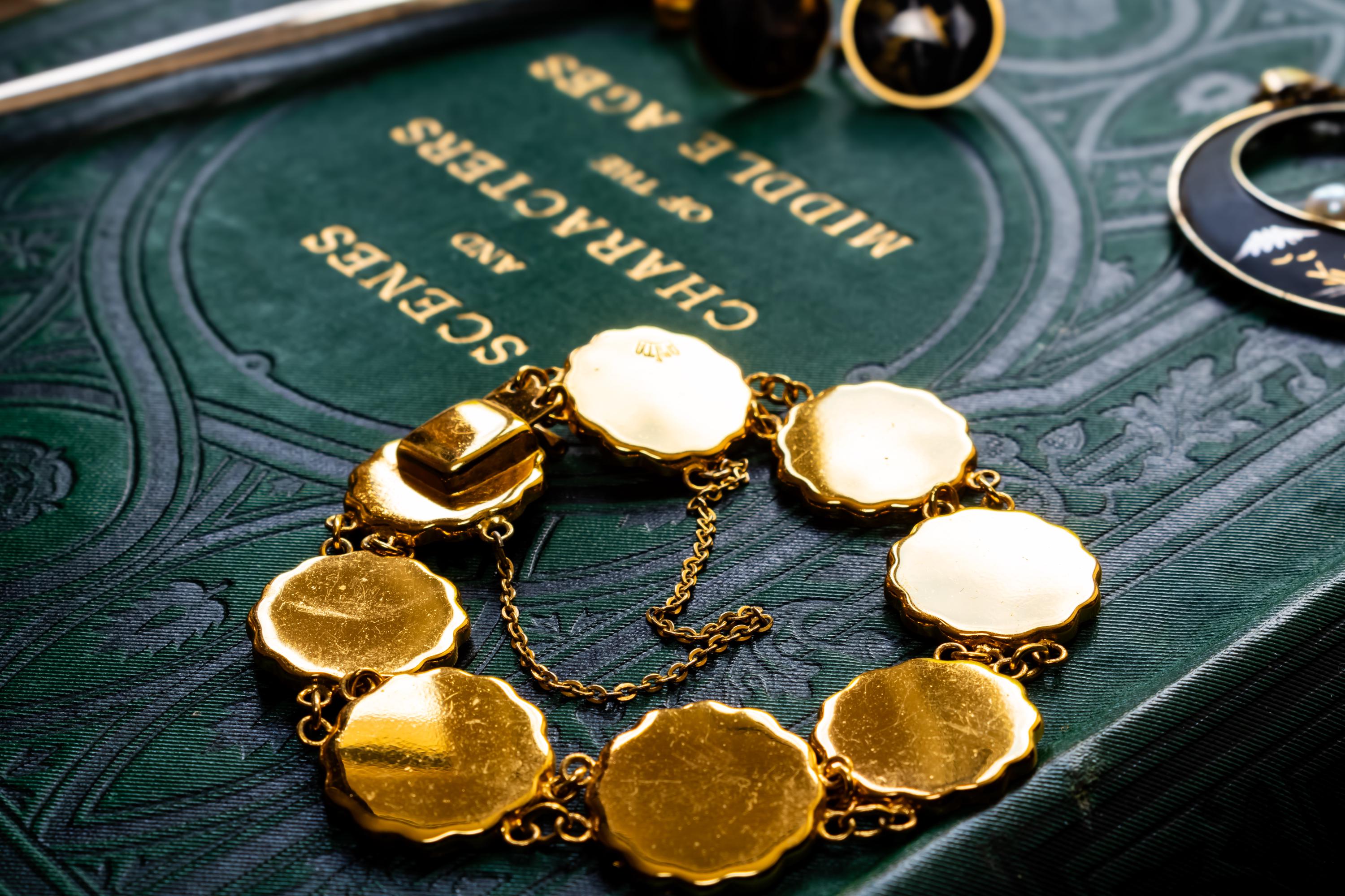 Vintage Amita Japanese damascene jewelry set including a necklace, bracelet, and earrings featuring black backgrounds with 24K gold inlay landscape scenes.