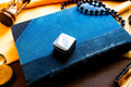 Vintage 2000 Birmingham silver square pill box featuring a smooth finish and a millennium stamp, resting on a blue antique book.