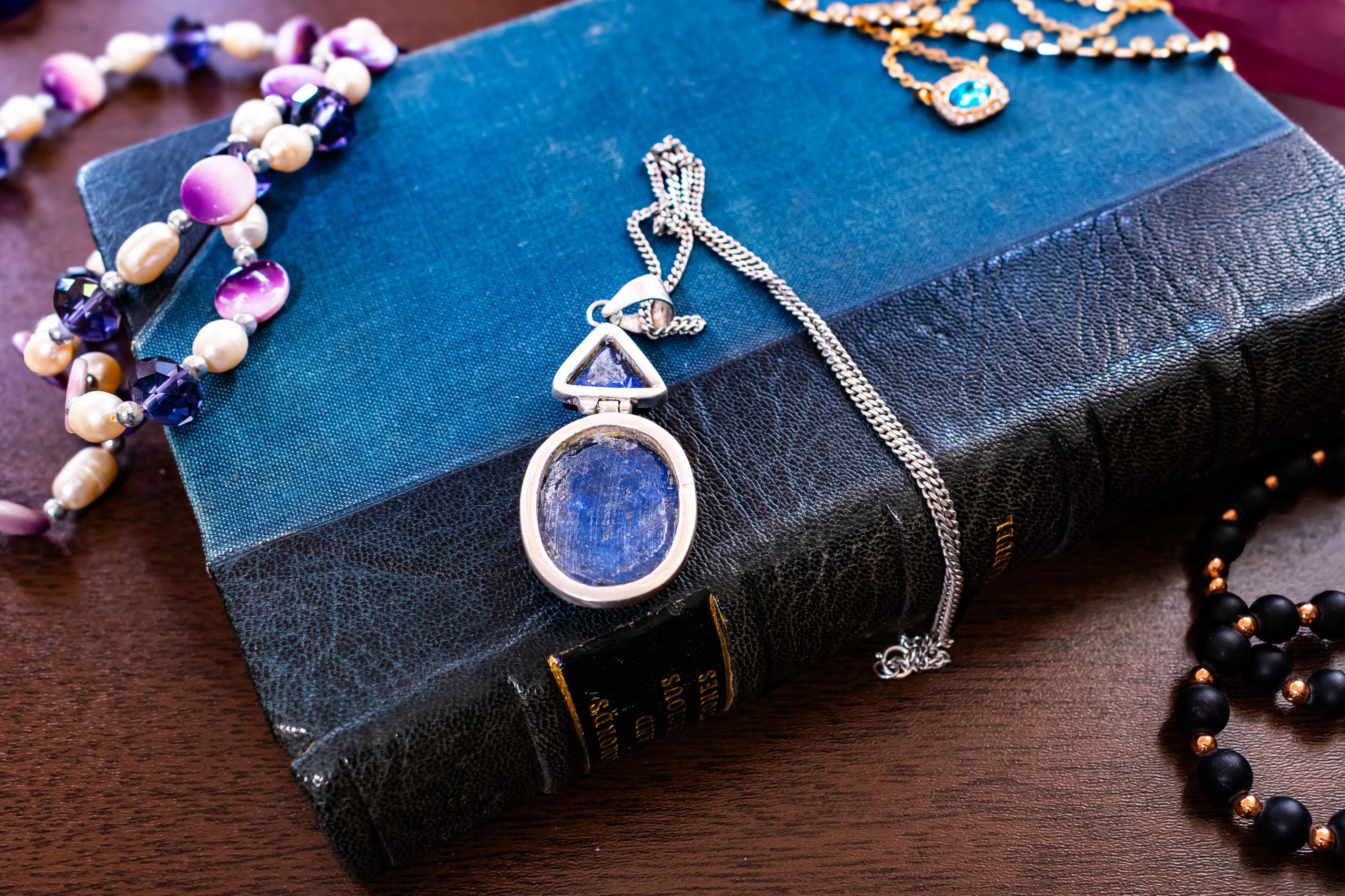 Heavy vintage sterling silver necklace featuring a large, deep blue lapis lazuli cabochon pendant with a secondary triangular lapis stone above it.