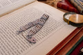 Heavy vintage sterling silver gate link bracelet featuring a safety chain and a classic heart padlock clasp, displayed on the pages of an antique text.