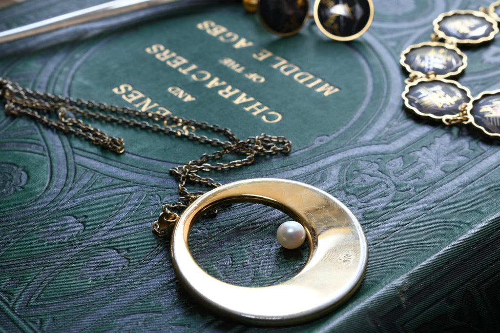 Vintage Amita Japanese damascene jewelry set including a necklace, bracelet, and earrings featuring black backgrounds with 24K gold inlay landscape scenes.