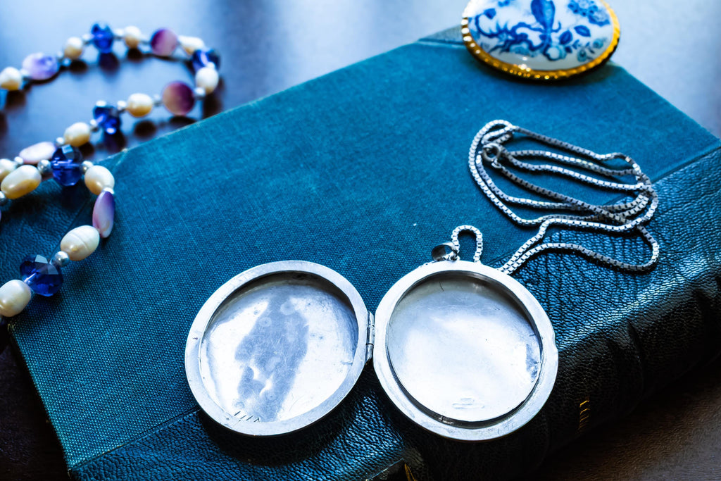 Large vintage sterling silver locket with a heavy box chain, featuring beautiful floral and scrollwork engraving on the front.