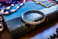 Vintage 1996 sterling silver flexible bangle with intricate engraved patterns along the band, sitting on a vintage blue book.